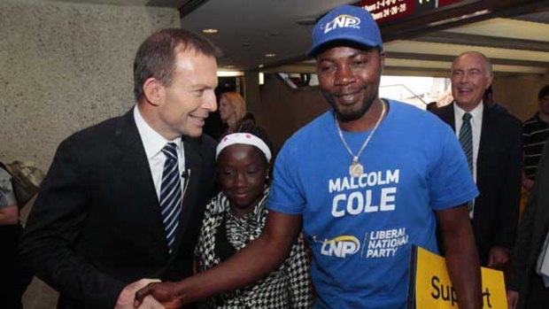 Tony Abbott with Mohamed Kamara and his daughter, Mafata, at the Coalition's Brisbane launch yesterday. <i>Picture: Glen McCurtayne</i>