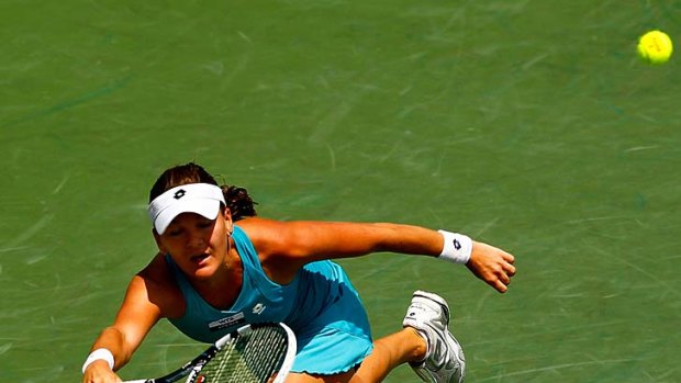 Agnieszka Radwanska stretches to effect a return to Maria Sharapova.