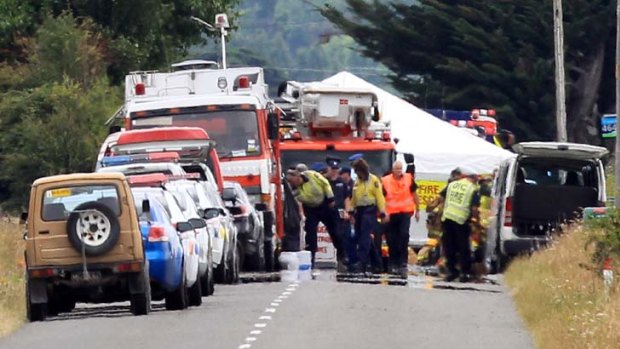 Fire and Police staff attend the accident site in Carterton, New Zealand.