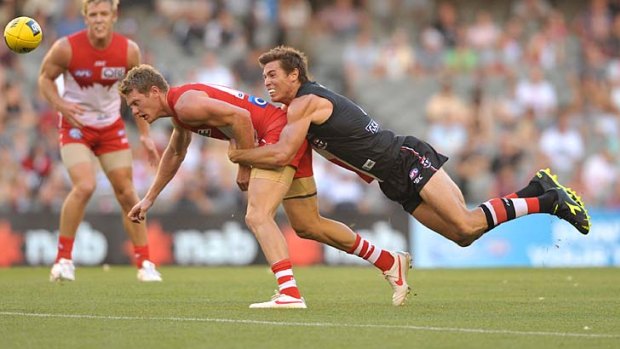 Welcome return:  Lenny Hayes, in his comeback game after injury, tackles Swan Mitch Morton last night at Etihad Stadium.