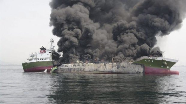 Smoke rises from the 1000-tonne fuel tanker Shoko Maru after it exploded off the coast of Himeji, western Japan.