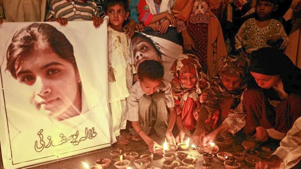 Pakistani children pray for the  recovery of child activist Malala Yousufzai.