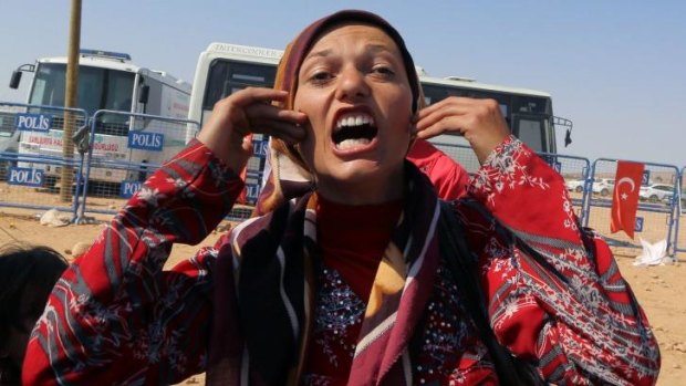 Syrian Kurdish refugee from Kobani, Zozan Nahsan, 21, shouts her anger, "where are the big powers, where is humanity? They kill us, Kobani is being massacred." 