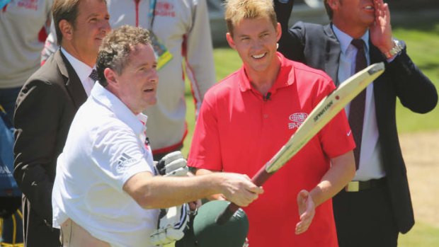Piers Morgan salutes the crowd after facing deliveries from former Test cricketer Brett Lee.