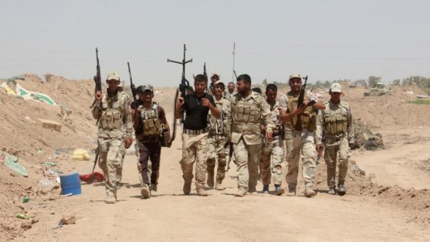 Iraqi volunteers who joined government forces to fight against Sunni jihadist militants of the Islamic State (IS) hold a position at a checkpoint in Udhaim, north of the capital Baghdad.