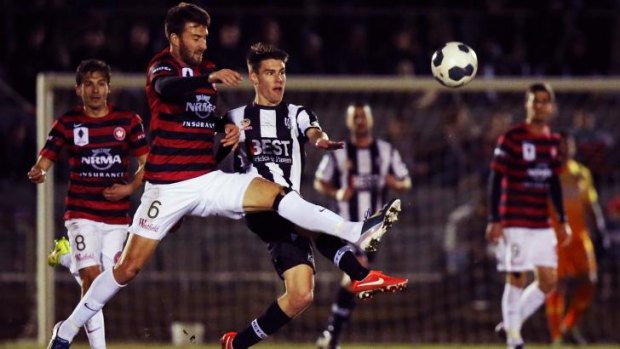 Giant killers: Antony Golec of Western Sydney competes for the ball with Joel Allwright of Adelaide City on Tuesday night. 