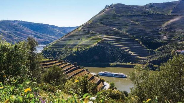 A Uniworld river cruise ship travels the Douro River in Portugal.