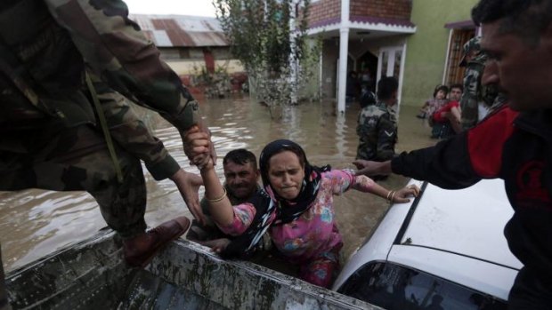 Indian army soldiers rescue a Kashmiri woman from her flooded house in Srinagar.