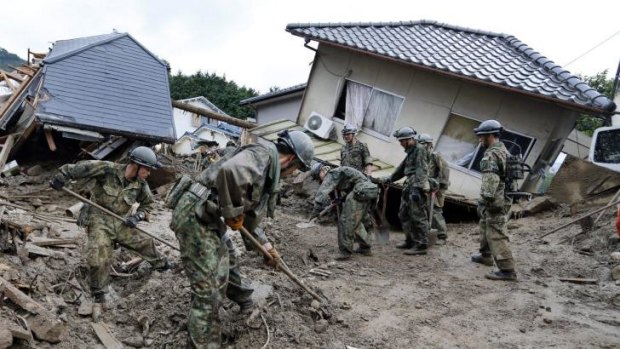 Self-defence personnel search for missing residents in Hiroshima.