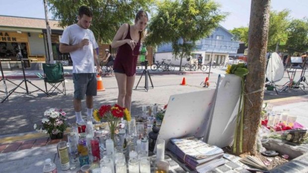 People look at a makeshift shrine outside a deli that was one of nine crime scenes after a series of drive-by shootings that left seven people dead in the Isla Vista neighbourhood of Santa Barbara, California.