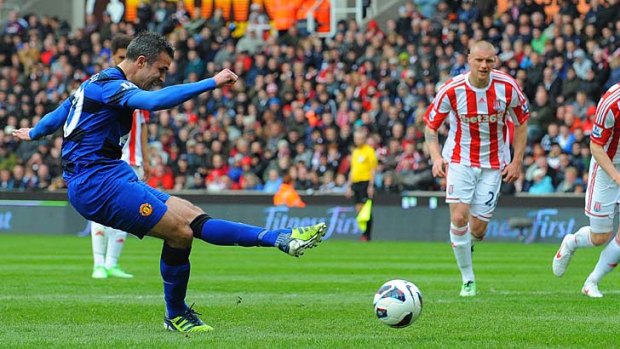 On the mark: Manchester United's Dutch forward Robin van Persie scores from the spot against Stoke City.