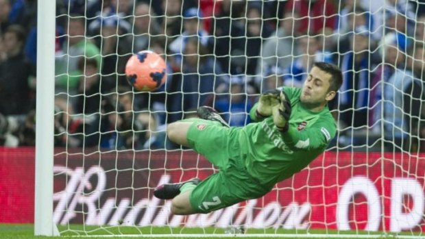Arsenal goalkeeper Lukasz Fabianski makes a save against Wigan.