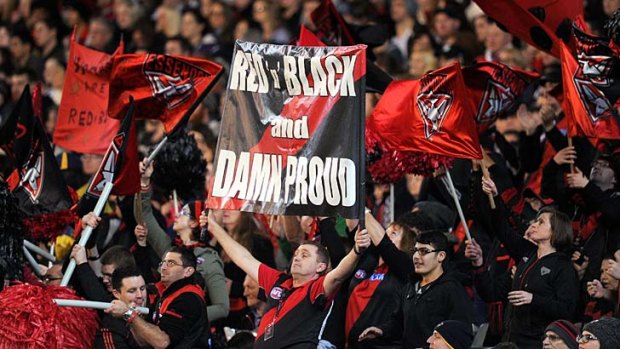 Keeping the faith: Essendon supporters show their true colours on Saturday night.