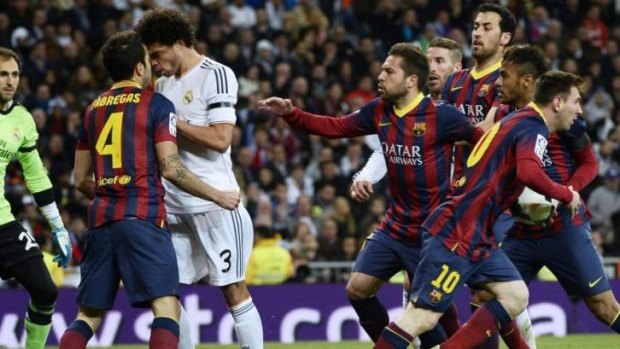 Heads collide: Cesc Fabregas (L) of Barcelona tangles with Real Madrid's Brazilian defender Marcelo.