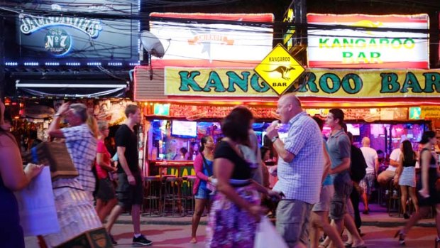 Some tourists "think that what happens in Australia happens here" ... tourists pass a bar in Soi Bangla, a bar district in Patong on the Thai island of Phuket.