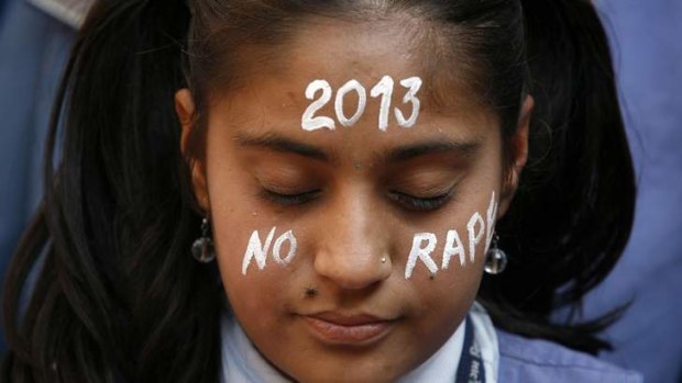 A student prays during a vigil for a gang rape victim in New Delhi, who died as a result of the attack.