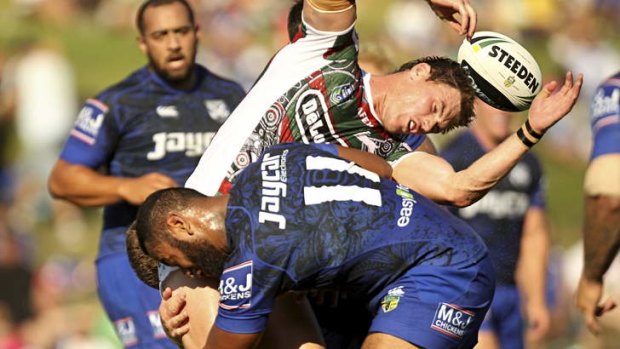Bruising: Souths Joe Picker is crunched by the Bulldogs defence.