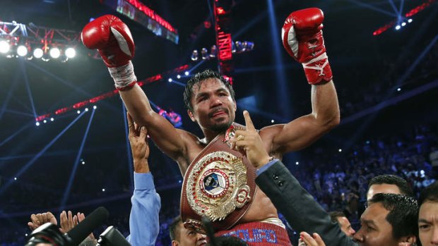 Manny Pacquiao from the Philippines wears the champion's belt after defeating Brandon Rios.