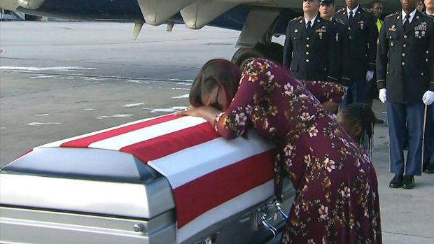 Myeshia Johnson cries over the casket in Miami of her husband Sergeant La David Johnson, killed in an ambush in Niger.