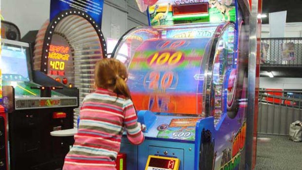 A six-year-old girl plays a redemption game in a children's entertainment arcade last week. <i>Photo: Ken Irwin</i>