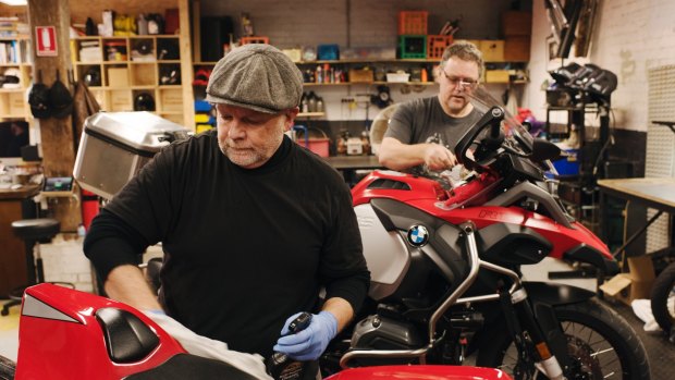 Rising Sun Workshop in Newtown. Sydney's first communal motorcycle workshop that provides space, tools, storage and expert advice for members to work on their motorcycles. Matt Laxton working on his Ducati and in the background Peter Whitfield working on his BMW GS.