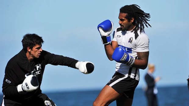 Leading hands: Scott Pendlebury and Harry O'Brien spar at Collingwood training.