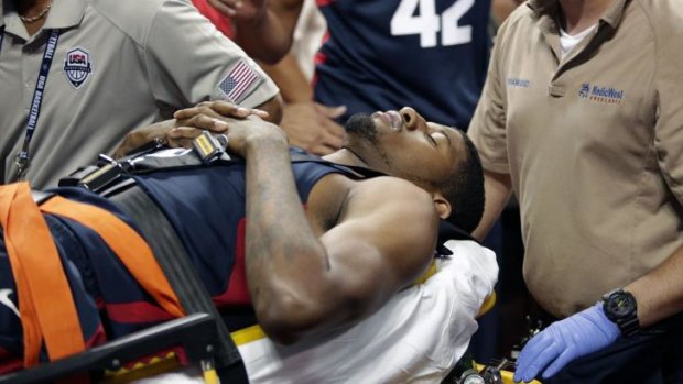 Stretchered off: Paul George is taken away for further treatment. The scrimmage was cancelled following his accident.