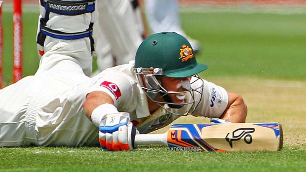 Mike Hussey slides along the ground as Sri Lanka attempts to run him out.