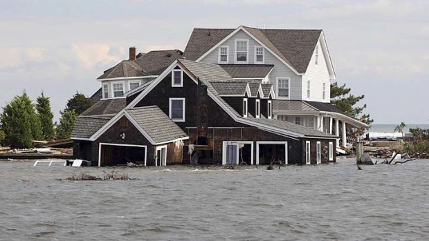 Spoiling the party ... hurricane Sandy brought devastation to the US Atlantic coast before Barack Obama was re-elected for a second term, below.
