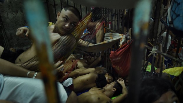 Prisoners at the Manila Police HQ rotate positions throughout the cell due to overcrowding.