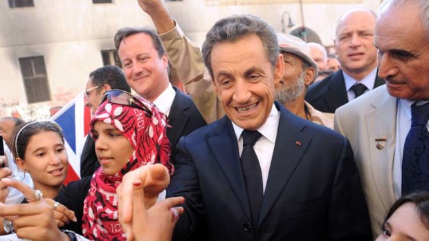 Basking in adulation ... Nicolas Sarkozy and David Cameron meet the locals in Benghazi.