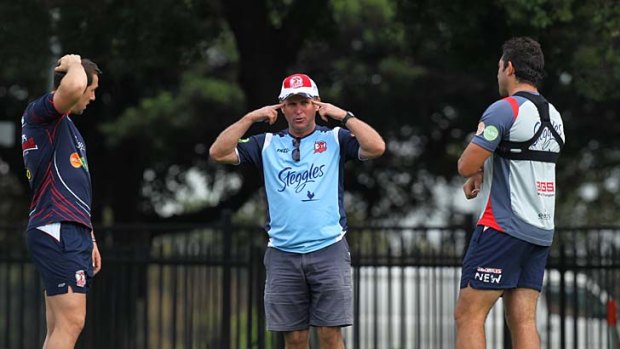 Searching for answers ... Roosters coach Brian Smith speaks to his halves pairing of Mitchell Pearce and Braith Anasta following the suspension of Todd Carney.