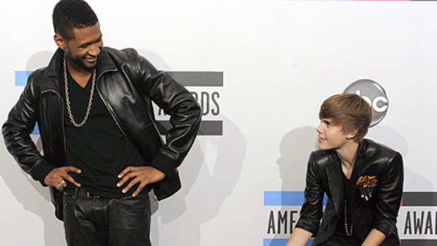Take that ... Justin Bieber shows off his awards to mentor Usher.