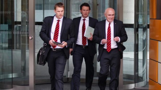 Essendon Chief Marketing Officer Justin Rodski, Chief Operating Officer  Xavier Campbell and Chairman Paul Little walk from the Federal Court building in June.