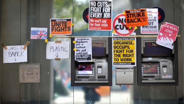 Placards cover two ATM machines outside St Paul's Cathedral in London yesterday.