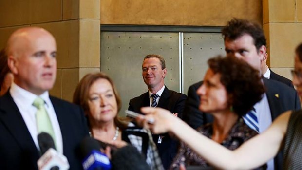 Minister for Education Christopher Pyne waits to speak while the state ministers hold a press conference in Sydney.