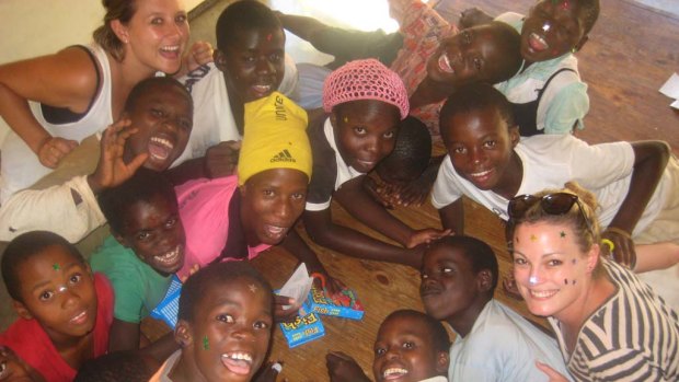 Fun and games ... Kristy Fraser-Kirk (right) and friend Katrina Brown with children at Kip Keino Orphanage in Zimbabwe.
