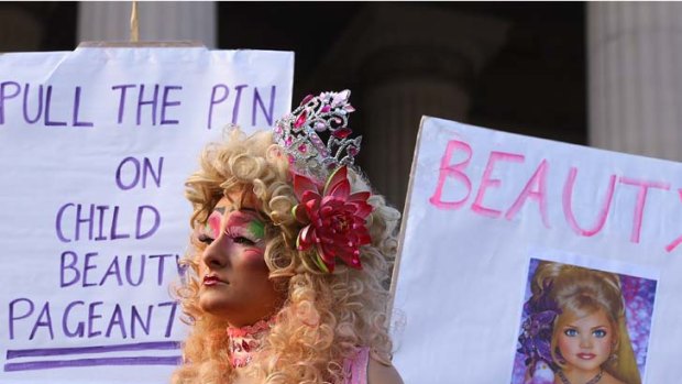 Protesters hold up signs during the 'Pull the Pin' rally against child beauty pageants at Parliament House in Melbourne last May.