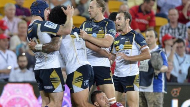 The Brumbies celebrate a try against the Reds.