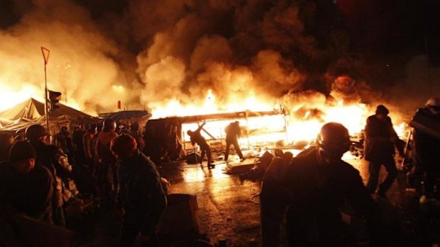 Anti-government protesters throw missiles during clashes with riot police at the Independence Square in Kiev.