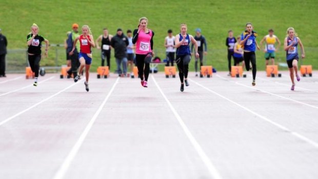 Melissa Breen, centre, ran an impressive 11.35 seconds in wet conditions at the AIS on Sunday.