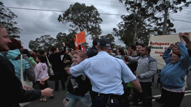 Desperate measures ... police clash with refugee supporters outside Villawood.