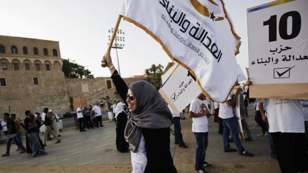 A supporter of the Justice and Construction Party, the political arm of the Muslim Brotherhood in Libya, waves a flag in Tripoli's Martyrs Square.