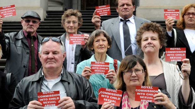 People in support of a royal commission into child sexual abuse in the Catholic Church on the steps of Parliament House in Melbourne yesterday.