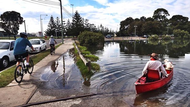 King Tide: The tide causes mild flooding Holbeach Avenue in Tempe.