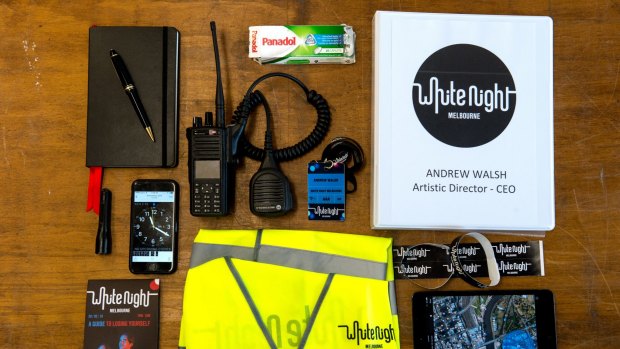 White Night artistic director Andrew Walsh's survival kit includes a diary, pen, radio, Panadol, folder, wrist bands, and iPad, flouro vest, program, phone, torch and a AAA access pass.