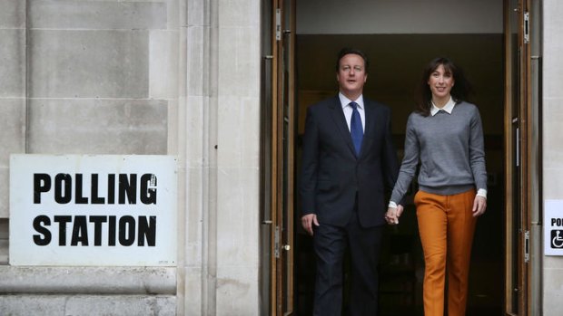 British PM David Cameron and his wife Samantha leave a polling station in London.