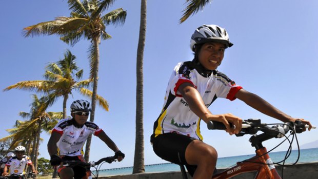 Francelina Cabal (right) and Caetano Barrito lead their team through Dili in preparation for the 450-kilometre Tour de Timor.
