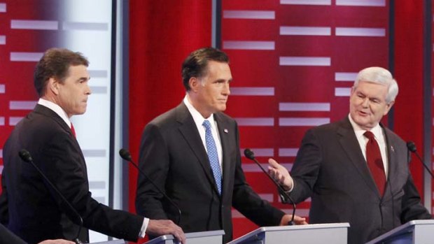 Republican presidential candidates Rick Perry (left), Mitt Romney (centre) and Newt Gingrich (right) at the Republican Party presidential candidates debate in Iowa on Saturday.