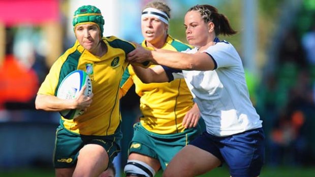 Nicole Beck of Australia is tackled by Elodie Poublan of France.